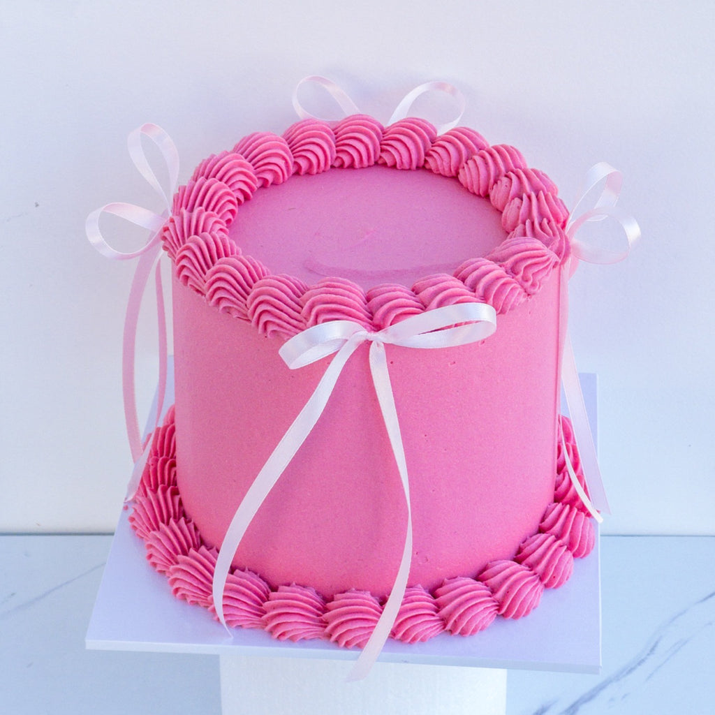 pink cake with pink bows